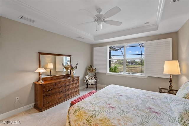 bedroom with a raised ceiling, light tile patterned floors, ceiling fan, and ornamental molding