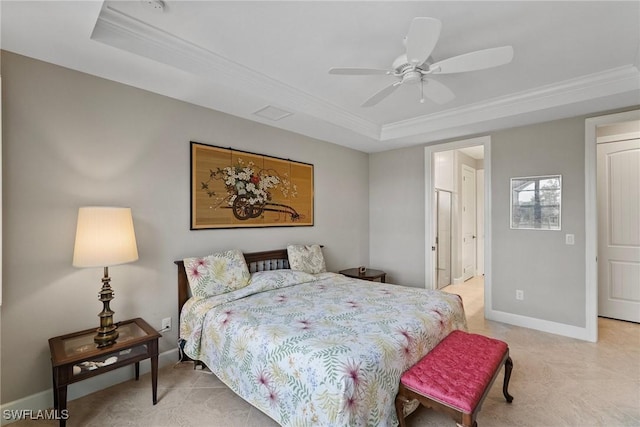 bedroom with a tray ceiling, ornamental molding, and ceiling fan