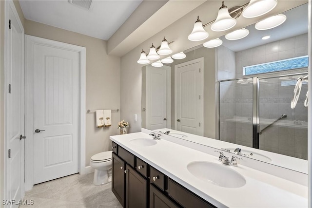 bathroom with an enclosed shower, vanity, and toilet