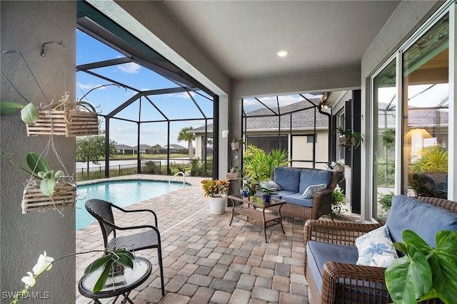 view of swimming pool featuring a lanai, an outdoor hangout area, and a patio area