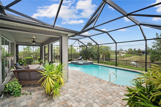 view of swimming pool with a patio area, an in ground hot tub, a lanai, ceiling fan, and an outdoor living space