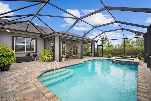 view of swimming pool featuring an in ground hot tub, glass enclosure, ceiling fan, and a patio area