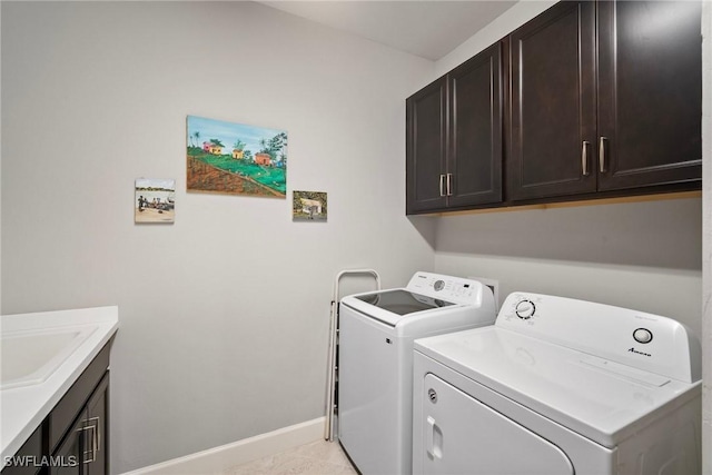 clothes washing area with cabinets, light tile patterned floors, sink, and independent washer and dryer