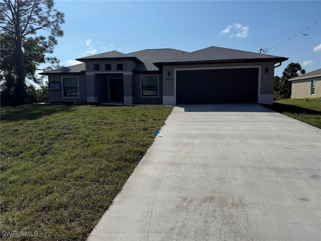 view of front of property with a garage and a front yard