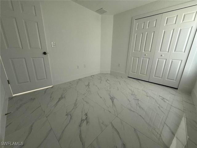 unfurnished bedroom with a closet