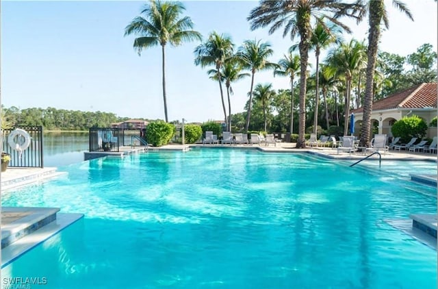 view of swimming pool featuring a water view