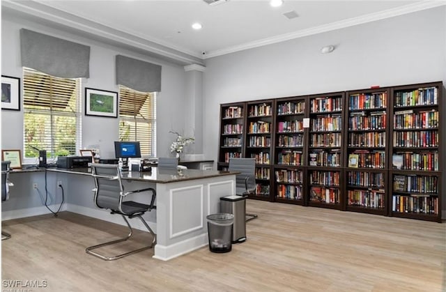 office area with light hardwood / wood-style flooring and ornamental molding