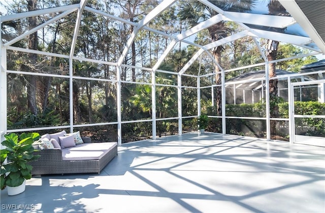 view of patio featuring an outdoor living space and a lanai