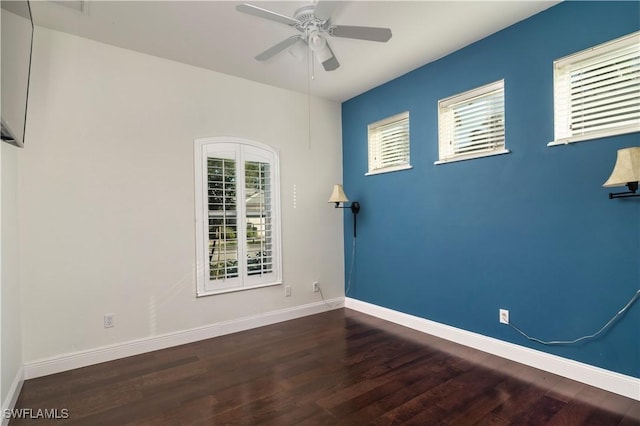 unfurnished room featuring plenty of natural light, dark hardwood / wood-style floors, and ceiling fan