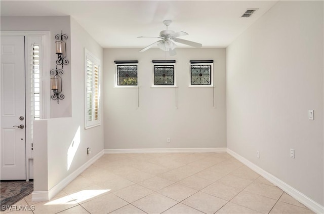 unfurnished room featuring light tile patterned floors and ceiling fan