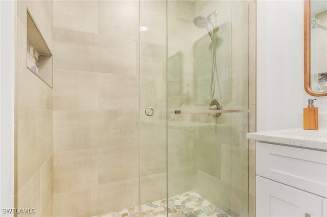 bathroom with vanity and a shower with door