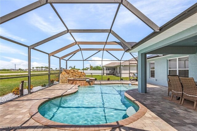 view of swimming pool with an in ground hot tub, a lanai, and a patio