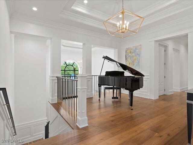 misc room with an inviting chandelier, ornamental molding, and light hardwood / wood-style floors