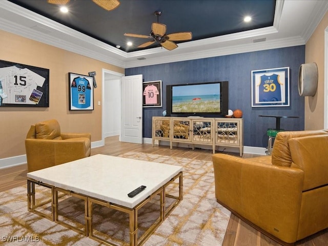 interior space featuring crown molding, a tray ceiling, and hardwood / wood-style flooring