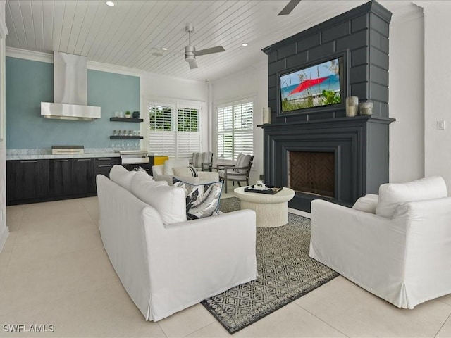 living room with crown molding, wood ceiling, ceiling fan, a fireplace, and light tile patterned flooring