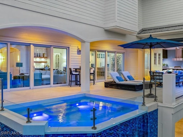 view of pool featuring a hot tub and a patio area