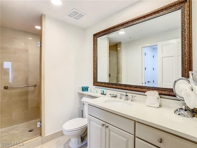 bathroom featuring a shower with door, vanity, and toilet