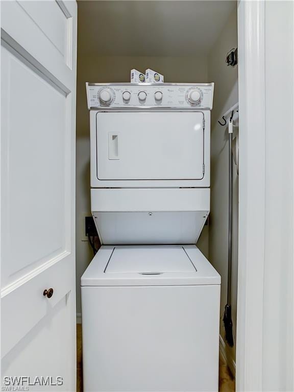 laundry area featuring stacked washing maching and dryer