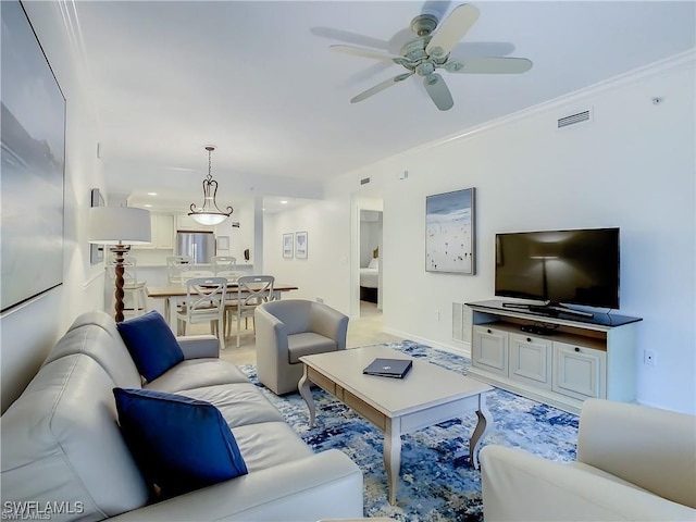 living room featuring crown molding and ceiling fan