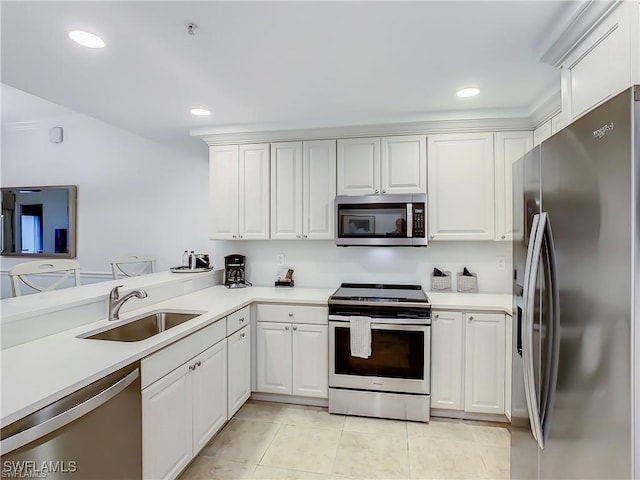 kitchen featuring light tile patterned flooring, sink, kitchen peninsula, stainless steel appliances, and white cabinets