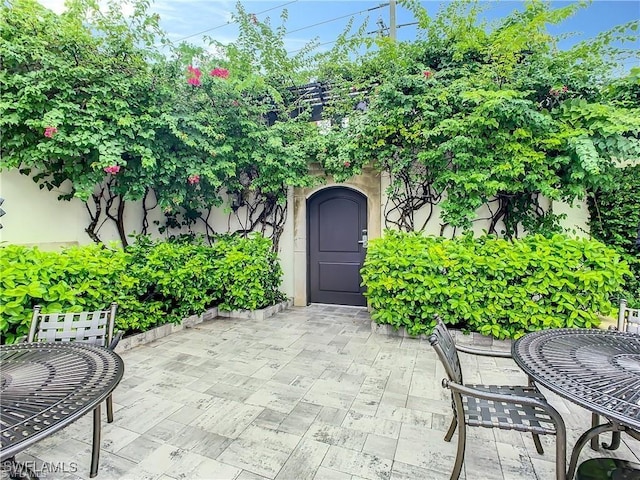 property entrance featuring a patio