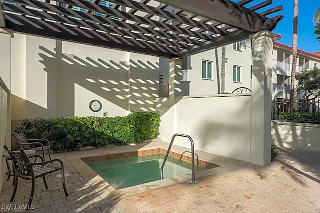 view of swimming pool featuring a hot tub and a pergola