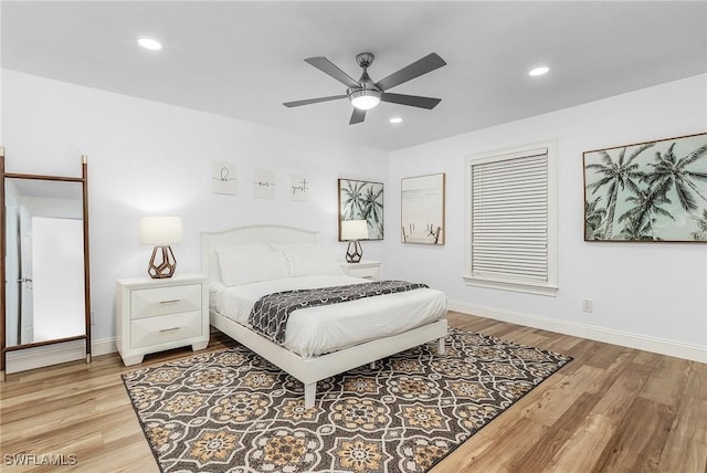 bedroom with ceiling fan and light hardwood / wood-style floors