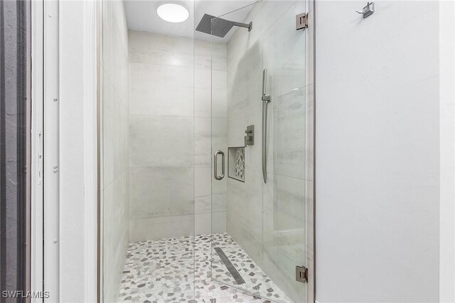 bathroom with a shower with shower door