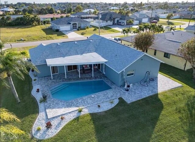 view of pool with a yard and a patio area