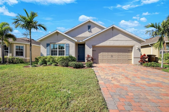 single story home featuring a garage and a front lawn