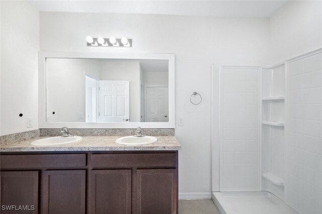 bathroom with vanity and a shower