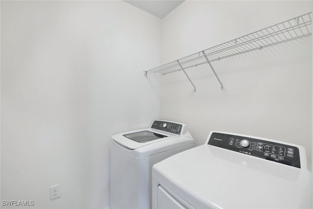 laundry area with independent washer and dryer