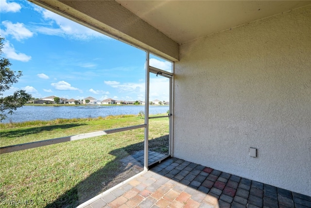 unfurnished sunroom with a water view