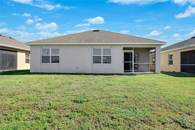 rear view of house featuring a yard