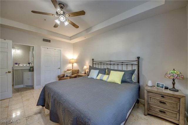 bedroom featuring ceiling fan and a tray ceiling