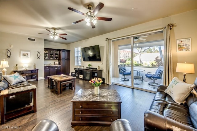 living room featuring plenty of natural light and dark hardwood / wood-style floors