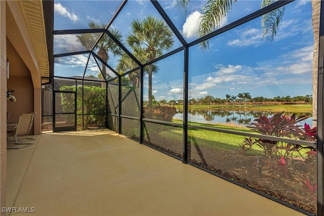 unfurnished sunroom featuring a water view