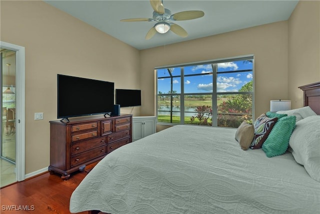 bedroom with ceiling fan and dark hardwood / wood-style flooring