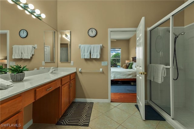 bathroom with tile patterned flooring, vanity, and walk in shower