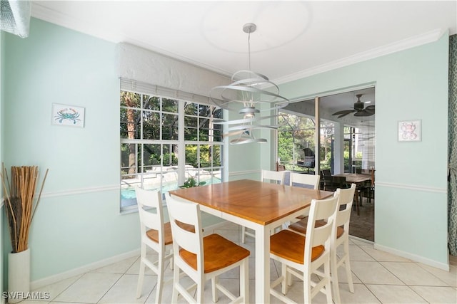 tiled dining room featuring ceiling fan, baseboards, and ornamental molding
