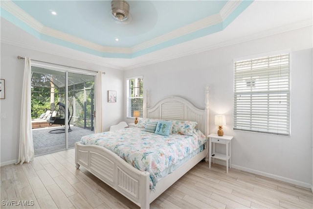 bedroom with crown molding, light wood-style floors, access to exterior, and a raised ceiling