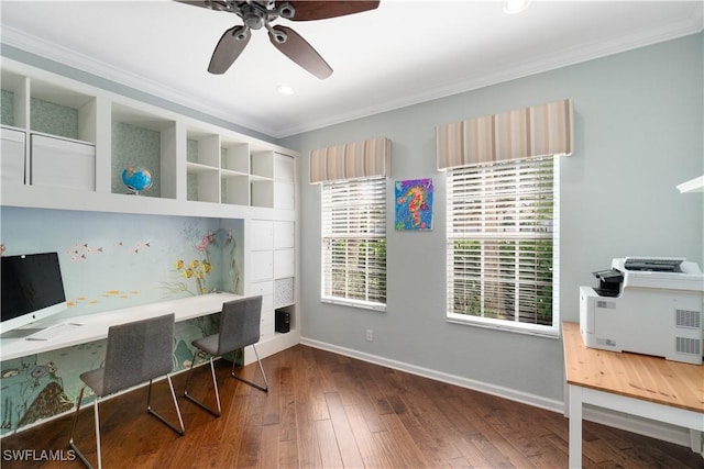 office space with baseboards, built in desk, ceiling fan, ornamental molding, and wood-type flooring