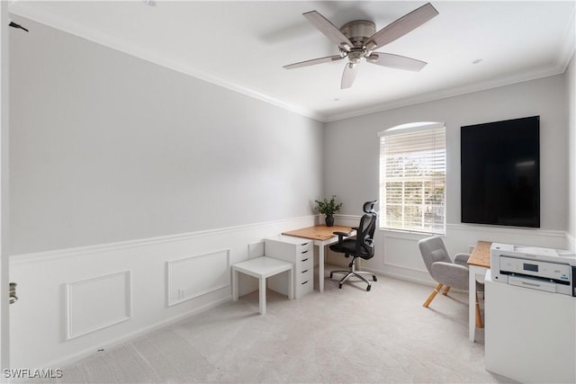 office featuring wainscoting, ornamental molding, a ceiling fan, and carpet