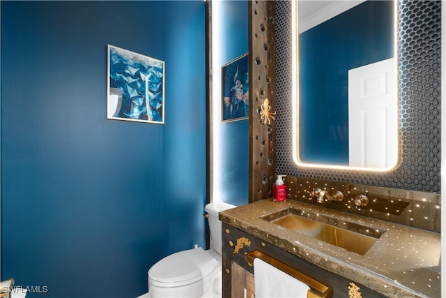 half bathroom with toilet and vanity