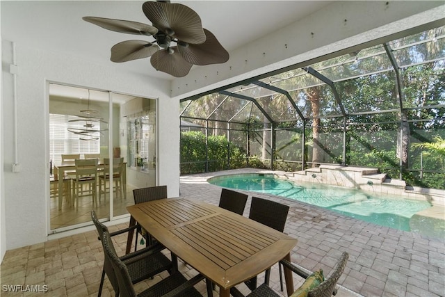 view of patio with glass enclosure, an outdoor pool, a ceiling fan, and outdoor dining area