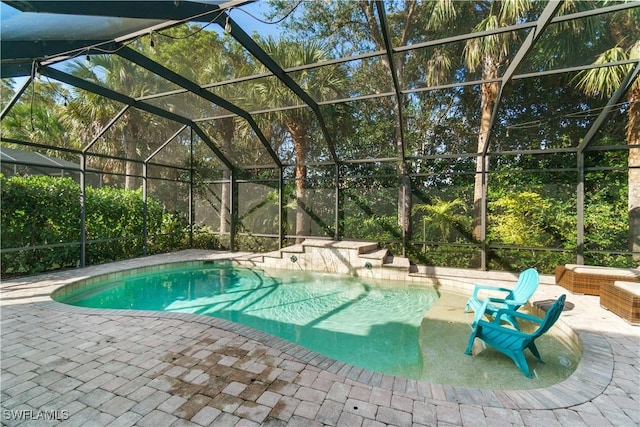 outdoor pool featuring a lanai and a patio