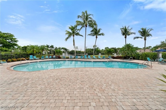 community pool featuring a patio and fence