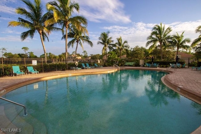 pool with fence and a patio