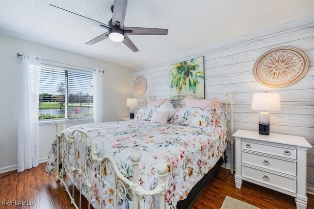 4572 Andover Way Unit C102, Naples, FL 34112 - bedroom featuring dark wood-style floors, ceiling fan, baseboards, and a textured ceiling