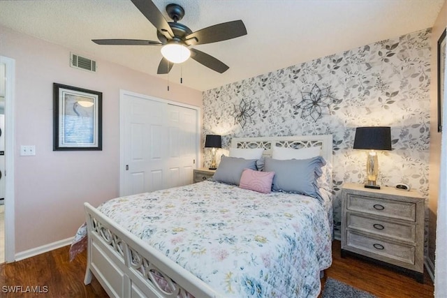 4572 Andover Way Unit C102, Naples, FL 34112 - bedroom with wallpapered walls, a closet, dark wood-style floors, and baseboards